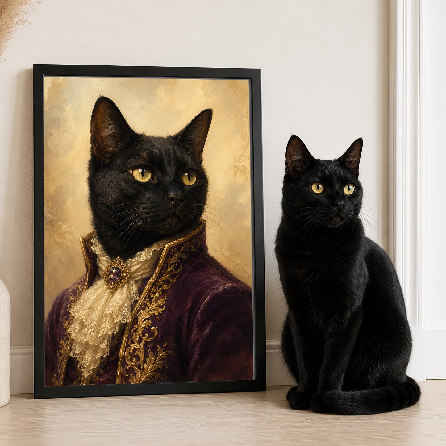 A black cat wearing a purple and gold outfit is sitting next to a framed portrait of the same cat.