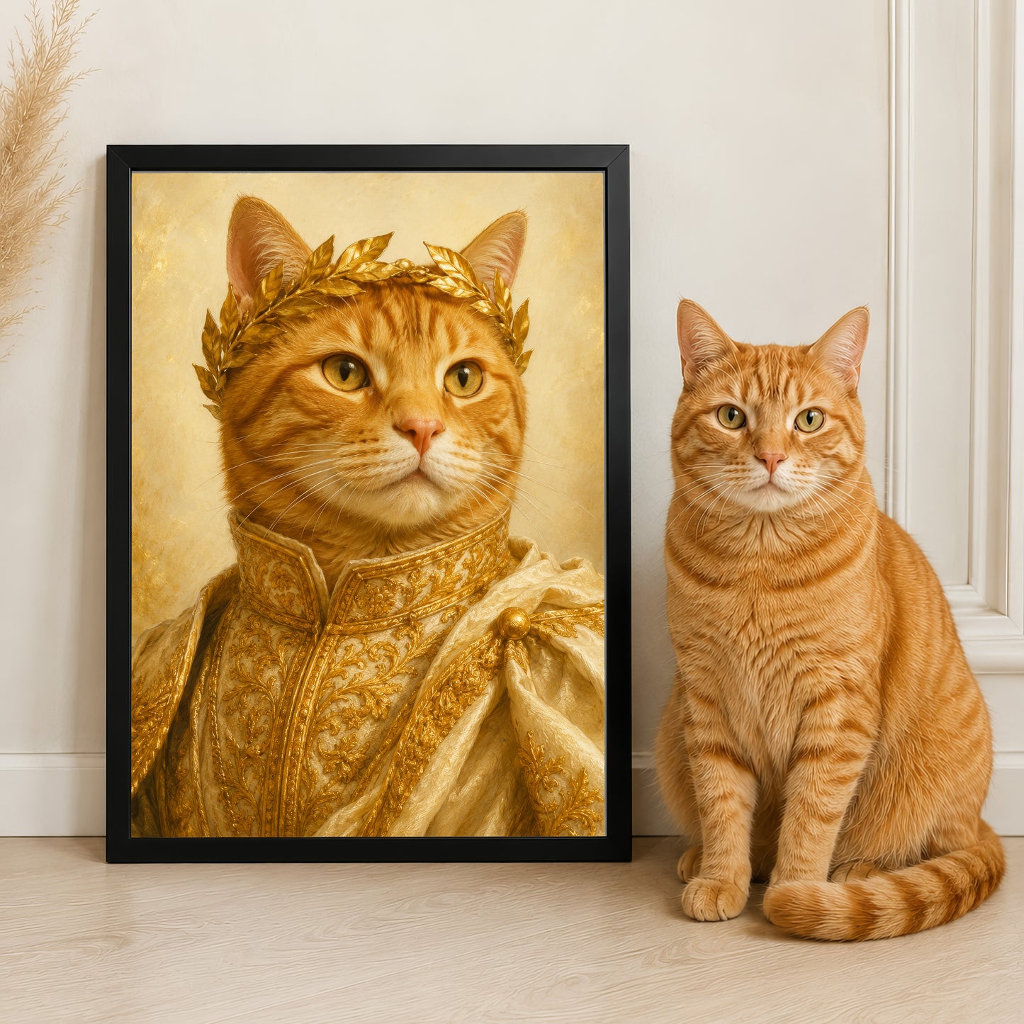 a large portrait of a cat wearing a golden crown, and a smaller cat sitting next to it.
